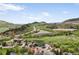 Aerial neighborhood view showcasing homes, green landscape, and mountain scenery, perfect for nature lovers at 225 Berthoud Way, Golden, CO 80401