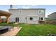A home exterior featuring a patio with fire pit, siding, and lush green backyard space for outdoor enjoyment at 225 Berthoud Way, Golden, CO 80401