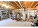 Unfinished basement with exposed ceiling, utility equipment, and ample storage shelving ready for customization at 225 Berthoud Way, Golden, CO 80401