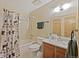 Well-lit bathroom with a shower/tub combo, linoleum flooring, and a vanity at 225 Berthoud Way, Golden, CO 80401