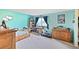 Brightly lit bedroom with hardwood furniture, plush carpet, and a window overlooking trees at 225 Berthoud Way, Golden, CO 80401