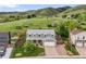 Charming two-story home with a well-maintained lawn and scenic views of rolling hills in the background at 225 Berthoud Way, Golden, CO 80401