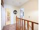 Upstairs hallway with wood railing and doors leading to bedrooms and a bathroom at 225 Berthoud Way, Golden, CO 80401