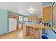Charming kitchen featuring wooden cabinets, a tiled island, and hardwood floors at 225 Berthoud Way, Golden, CO 80401