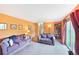 Bright living room with carpet, orange walls, and sliding glass door to a fenced backyard at 225 Berthoud Way, Golden, CO 80401