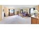 Spacious main bedroom with plush carpet, two windows, and furnished with dressers and nightstands at 225 Berthoud Way, Golden, CO 80401