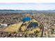 Aerial view shows lakes, baseball fields, and the surrounding residential area with distant mountain views at 2237 S Lowell Blvd, Denver, CO 80219