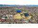 An aerial view showcases the neighborhood lakes, community fields, and surrounding residential area at 2237 S Lowell Blvd, Denver, CO 80219