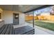 Back Porch with a wooden seating area, a grey back door, and view of the green backyard at 2237 S Lowell Blvd, Denver, CO 80219