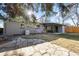 Backyard view with stone patio and covered porch at 2237 S Lowell Blvd, Denver, CO 80219