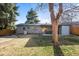 Cozy backyard with healthy green grass, patio and shade tree at 2237 S Lowell Blvd, Denver, CO 80219