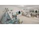 Open basement area featuring neutral tones, a play area, and a comfortable seating area with a large screen TV at 2237 S Lowell Blvd, Denver, CO 80219