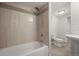Bathroom featuring a shower and tub combination with tiled walls, and a modern sink and toilet at 2237 S Lowell Blvd, Denver, CO 80219