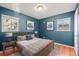 Calming bedroom with blue walls, warm wood floors, and plenty of natural light at 2237 S Lowell Blvd, Denver, CO 80219