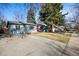 Charming one-story home with a well-maintained lawn and a bright red front door at 2237 S Lowell Blvd, Denver, CO 80219