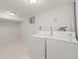 Functional laundry room with a standard-size washer and dryer, offering convenience and practicality at 2237 S Lowell Blvd, Denver, CO 80219