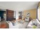 A bright and open living space with modern decor, hardwood floors, and a view to a kitchen area at 2237 S Lowell Blvd, Denver, CO 80219