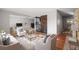Open-concept living room showcasing modern decor, wood floors, and a seamless transition to the kitchen at 2237 S Lowell Blvd, Denver, CO 80219