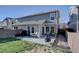 A backyard view highlights the trex deck, patio area, and grassy yard of the property at 5936 Turnstone Pl, Castle Rock, CO 80104