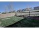 Large, grassy backyard with a wood fence and a view of surrounding homes at 5936 Turnstone Pl, Castle Rock, CO 80104