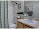 Bright bathroom with vanity, framed mirror, and shower-tub combo with decorative shower curtain at 5936 Turnstone Pl, Castle Rock, CO 80104