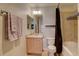 Bright bathroom featuring a vanity, toilet, and shower-tub combination at 5936 Turnstone Pl, Castle Rock, CO 80104