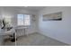 A bright bedroom space featuring a built-in desk under the window and neutral carpeting at 5936 Turnstone Pl, Castle Rock, CO 80104