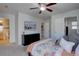 Comfortable bedroom with a wall-mounted television and adjacent bathroom at 5936 Turnstone Pl, Castle Rock, CO 80104