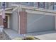 A welcoming home exterior featuring brick accents, and a well-lit walkway at 5936 Turnstone Pl, Castle Rock, CO 80104