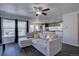 An open-concept living room with dark wood floors and a comfortable gray sectional sofa at 5936 Turnstone Pl, Castle Rock, CO 80104