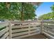Balcony view showcasing a parking lot and greenery and a white wood railing at 8555 Fairmount Dr # A108, Denver, CO 80247