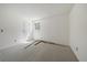 A bright, carpeted bedroom with a window and door for natural light and white walls at 8555 Fairmount Dr # A108, Denver, CO 80247