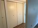 Hallway storage area with large closet doors at 8555 Fairmount Dr # A108, Denver, CO 80247