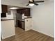 Open concept kitchen with stainless steel appliances and dark wood cabinets at 8555 Fairmount Dr # A108, Denver, CO 80247