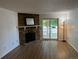Bright living room with a stone fireplace and sliding glass doors to the outside at 8555 Fairmount Dr # A108, Denver, CO 80247