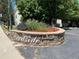 Community entrance sign surrounded by decorative flowers and greenery at 8555 Fairmount Dr # A108, Denver, CO 80247