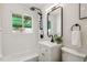 Updated bathroom features modern fixtures, stylish vanity, and a shower with a sleek black showerhead and subway tile at 3550 Fairfax St, Denver, CO 80207