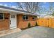 Attractive brick home with a pristine white door and fresh landscaping, perfect curb appeal at 3550 Fairfax St, Denver, CO 80207