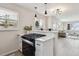 Open kitchen layout showcasing stainless steel appliances, a breakfast bar, and seamless connection to the living area at 3550 Fairfax St, Denver, CO 80207