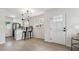 Eat-in kitchen with bright white cabinets, stainless appliances, and modern lighting at 3550 Fairfax St, Denver, CO 80207