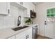 Modern kitchen boasting white cabinets, stainless steel appliances, and sleek countertops at 3550 Fairfax St, Denver, CO 80207