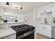 Modern kitchen featuring stainless steel appliances, quartz countertops, and an open layout with stylish pendant lighting at 3550 Fairfax St, Denver, CO 80207
