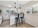 Charming kitchen features a breakfast bar, stainless steel appliances, and ample natural light at 3550 Fairfax St, Denver, CO 80207