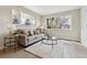 Inviting living room featuring a comfy gray sofa, large windows, and stylish decor at 3550 Fairfax St, Denver, CO 80207