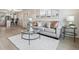 Open-concept living room seamlessly connecting to a modern kitchen, with light hardwood floors at 3550 Fairfax St, Denver, CO 80207