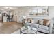 Inviting living room with hardwood floors, a comfortable sofa, and seamless connection to the modern kitchen at 3550 Fairfax St, Denver, CO 80207