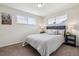 Cozy main bedroom with ample natural light, carpet, and calming decor; perfect for rest and relaxation at 3550 Fairfax St, Denver, CO 80207