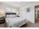 Comfortable main bedroom featuring neutral tones, carpet, and ample natural light from large windows at 3550 Fairfax St, Denver, CO 80207