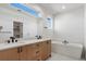 Bright bathroom with double vanity, a soaking tub, and sleek fixtures at 5604 Grandville Ave, Longmont, CO 80503
