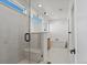Modern bathroom featuring glass enclosed shower with bench and a soaking tub at 5604 Grandville Ave, Longmont, CO 80503